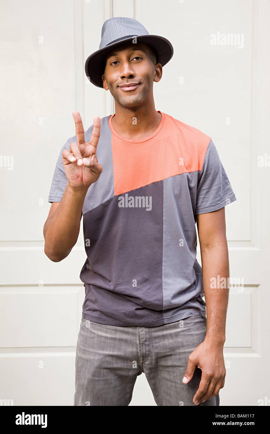 Man wearing fedora et faisant signe de la paix Banque D'Images