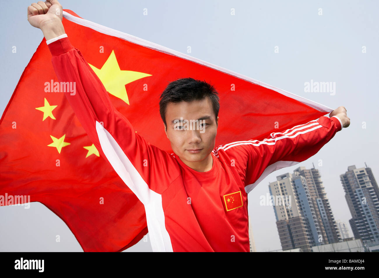 L'athlète chinois tenant le drapeau chinois avec fierté Banque D'Images