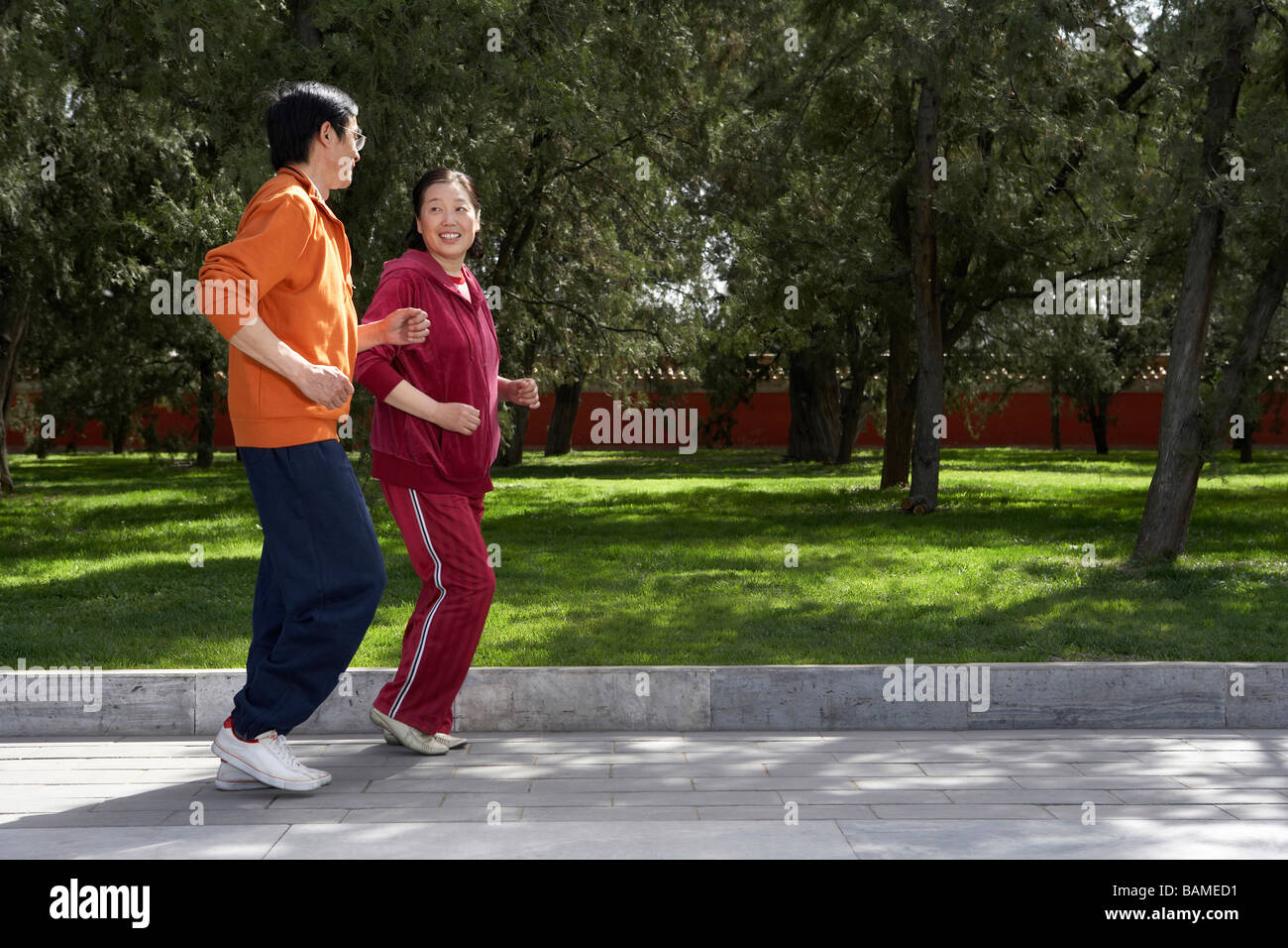 Couple Jogging chinois par Park Banque D'Images