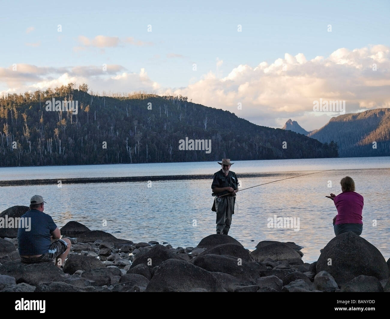 Homme plus âgé fly fisherman talking to couple on Lake St Clair Tasmanie Australie Banque D'Images