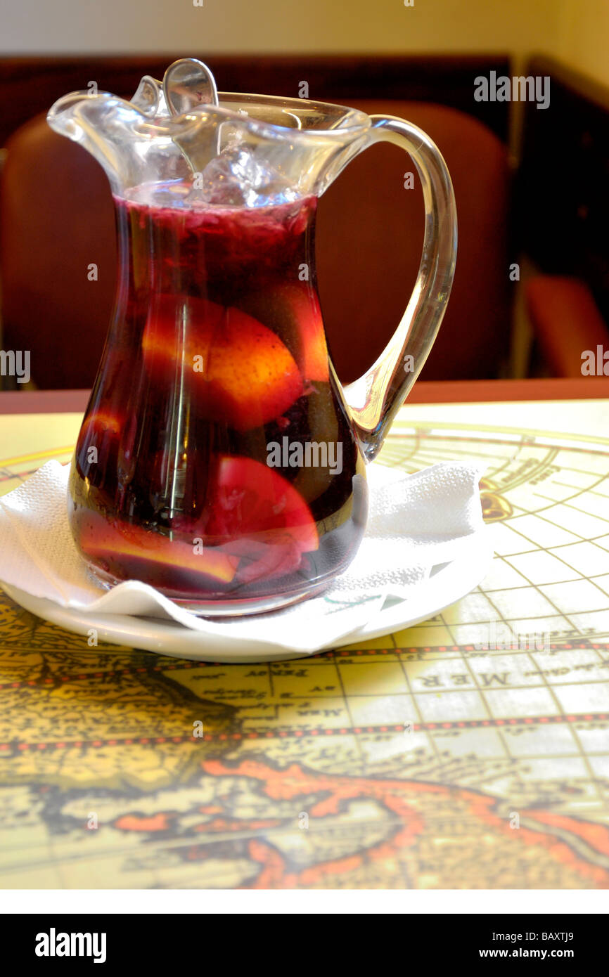 Pichet en verre de sangria sur une carte du monde table. Banque D'Images