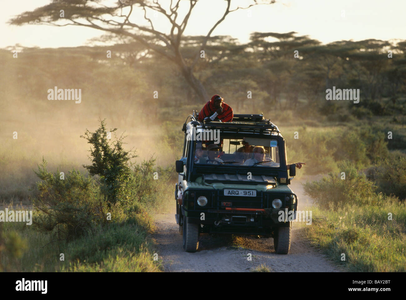 Les touristes en safari avec guide massai, Serengeti, Tanzanie, Afrique de l'Est Banque D'Images