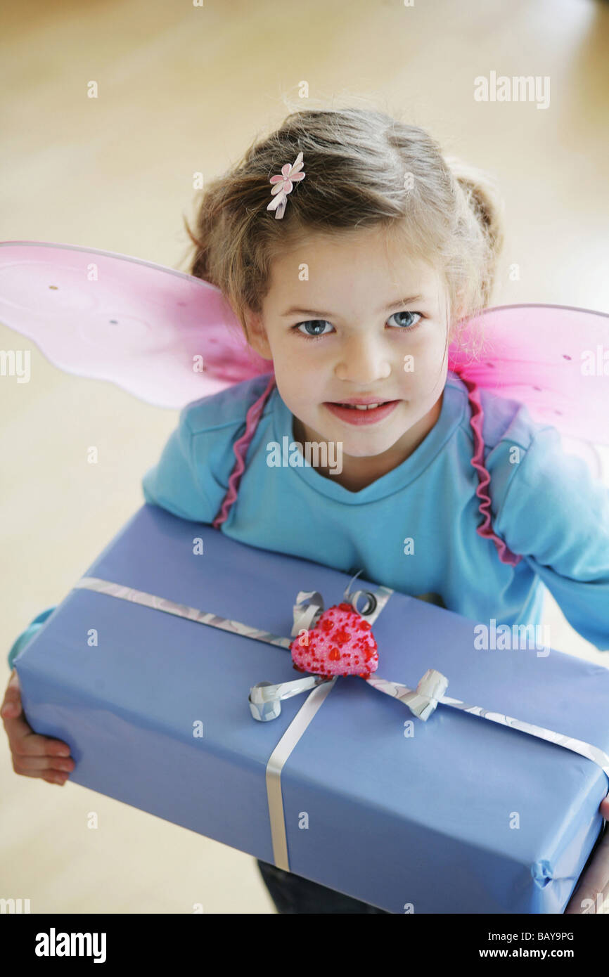 Girl (3-4 ans) portant des ailes de papillon avec présent Banque D'Images