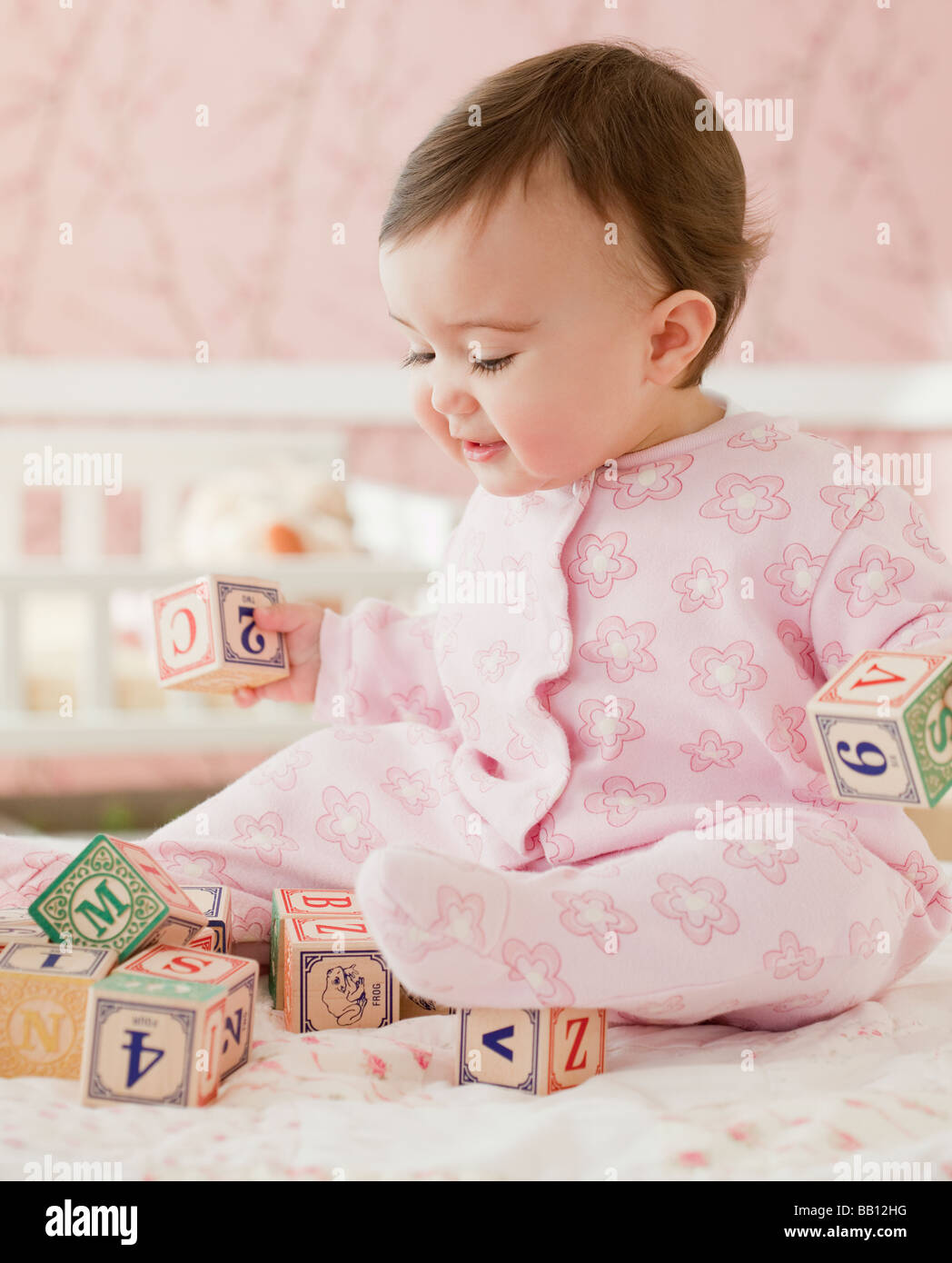 Mixed Race baby girl Playing with alphabet blocks Banque D'Images