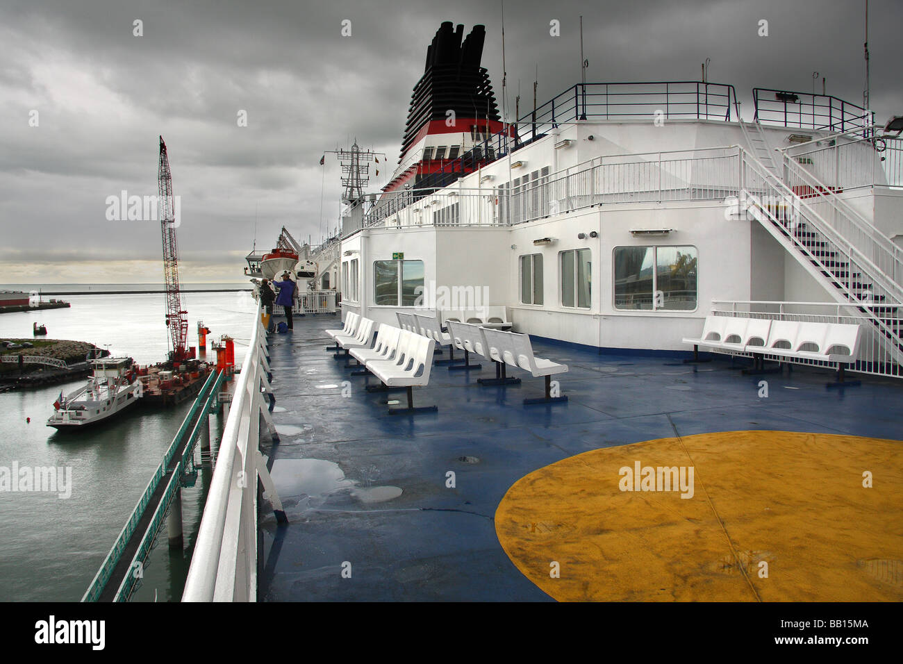 Un cross channel ferry au Havre sous un ciel d'orage avec une grue de voile d'un côté. France Banque D'Images