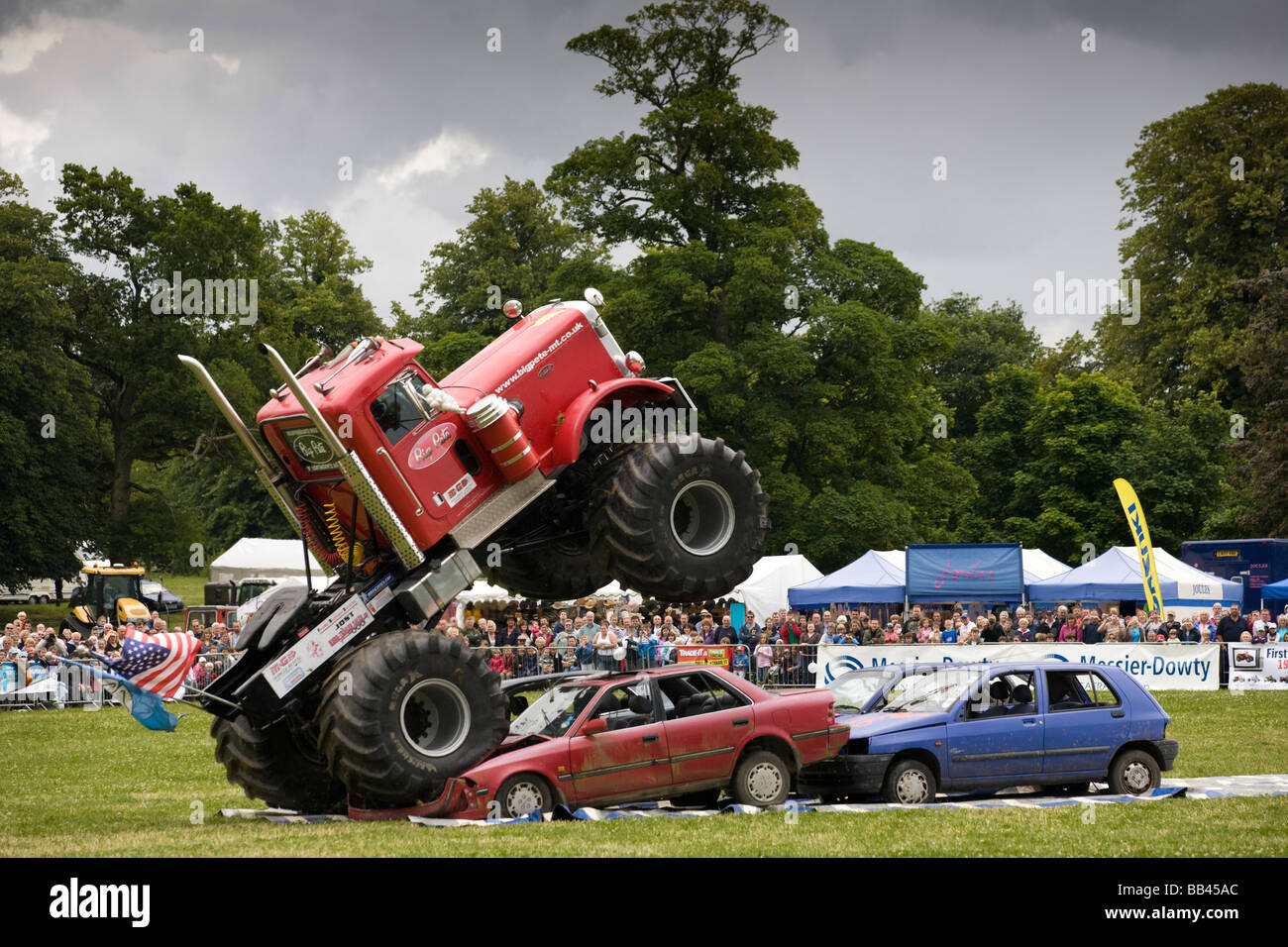 Monster trucks écrasement de vieilles voitures lors d'une foire agricole, Gloucestershire, Royaume-Uni Banque D'Images