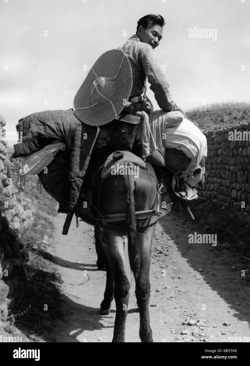 Géographie / voyages, Chine, gens, commerçant chinois de biens de seconde main sur le chemin d'une foire de village, 2ème moitié du XXe siècle, historique, historique, assis sur âne, chapeau, panier, souriant, marché, Banque D'Images