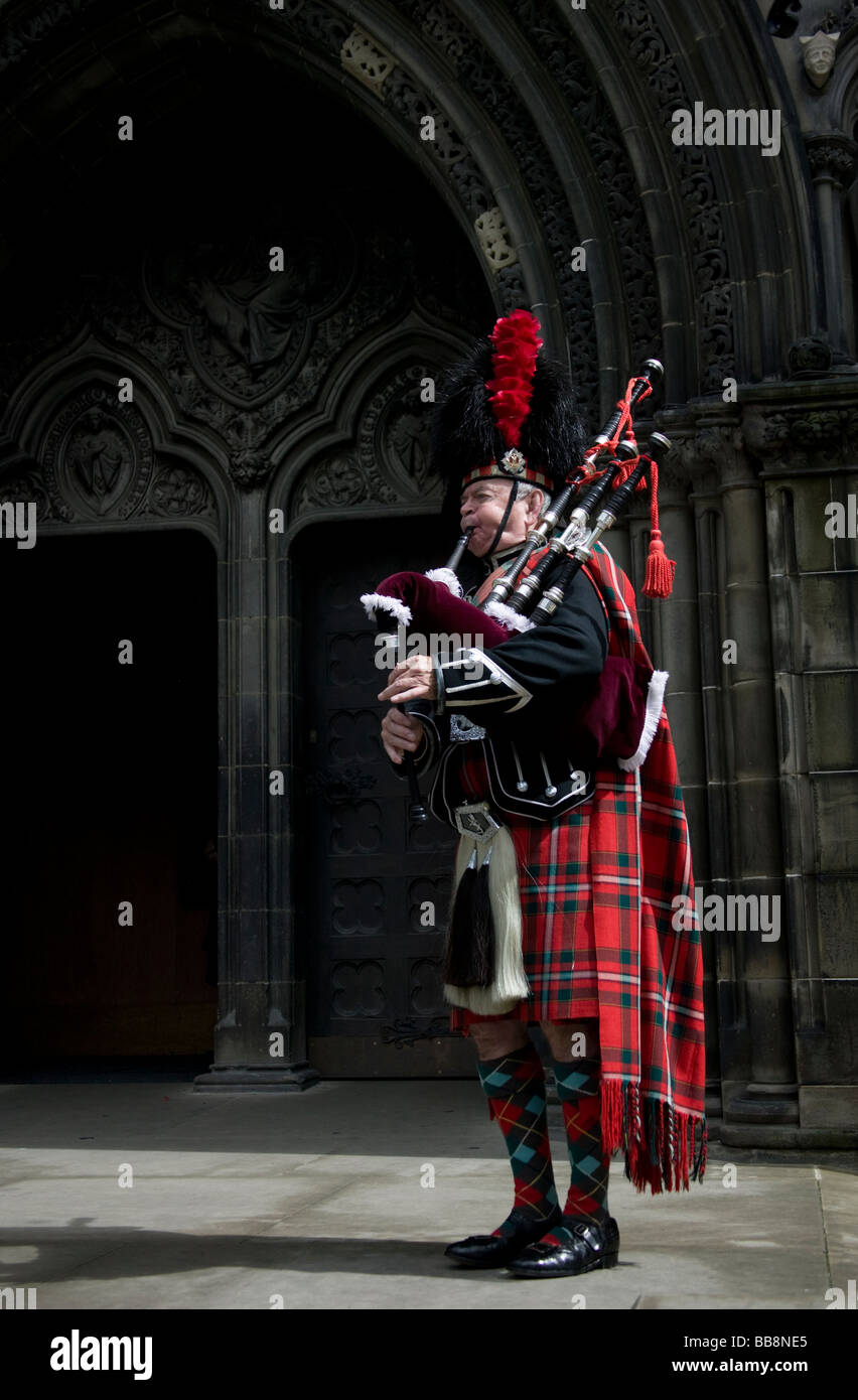 Piper mâle jouant cornemuses écossaises à l'extérieur de 'St Giles' Church, Édimbourg, Écosse, Royaume-Uni, Europe Banque D'Images