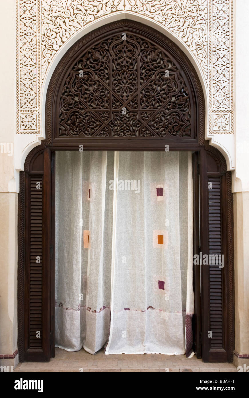 Rideaux décoratifs dans un stuccod arcade mauresque cacher une pièce cachée, la Villa des Orangers, Marrakech, Maroc Banque D'Images