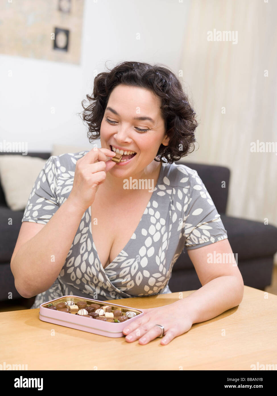 Woman eating chocolate candy Banque D'Images