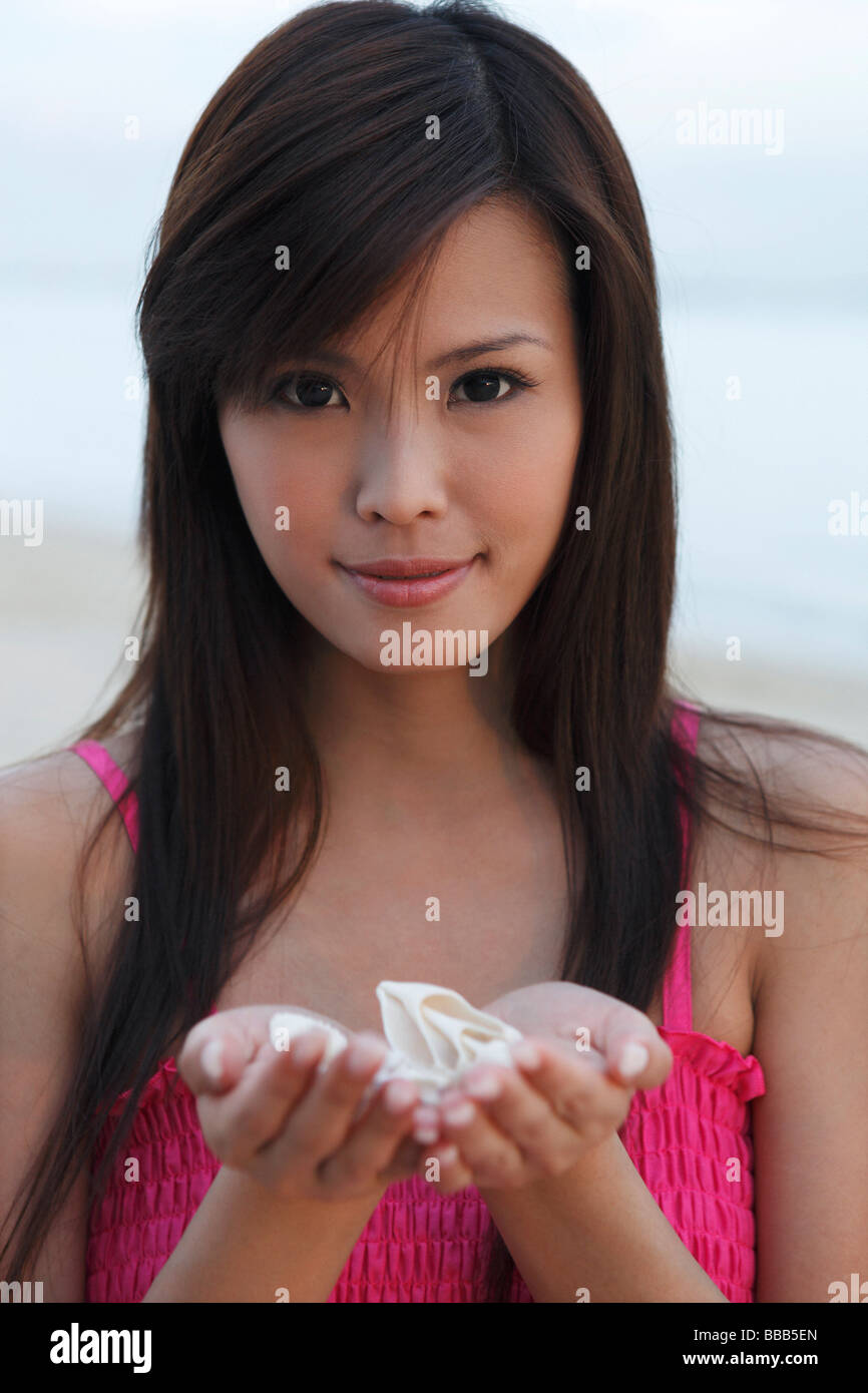 Woman holding seashell au creux des mains Banque D'Images