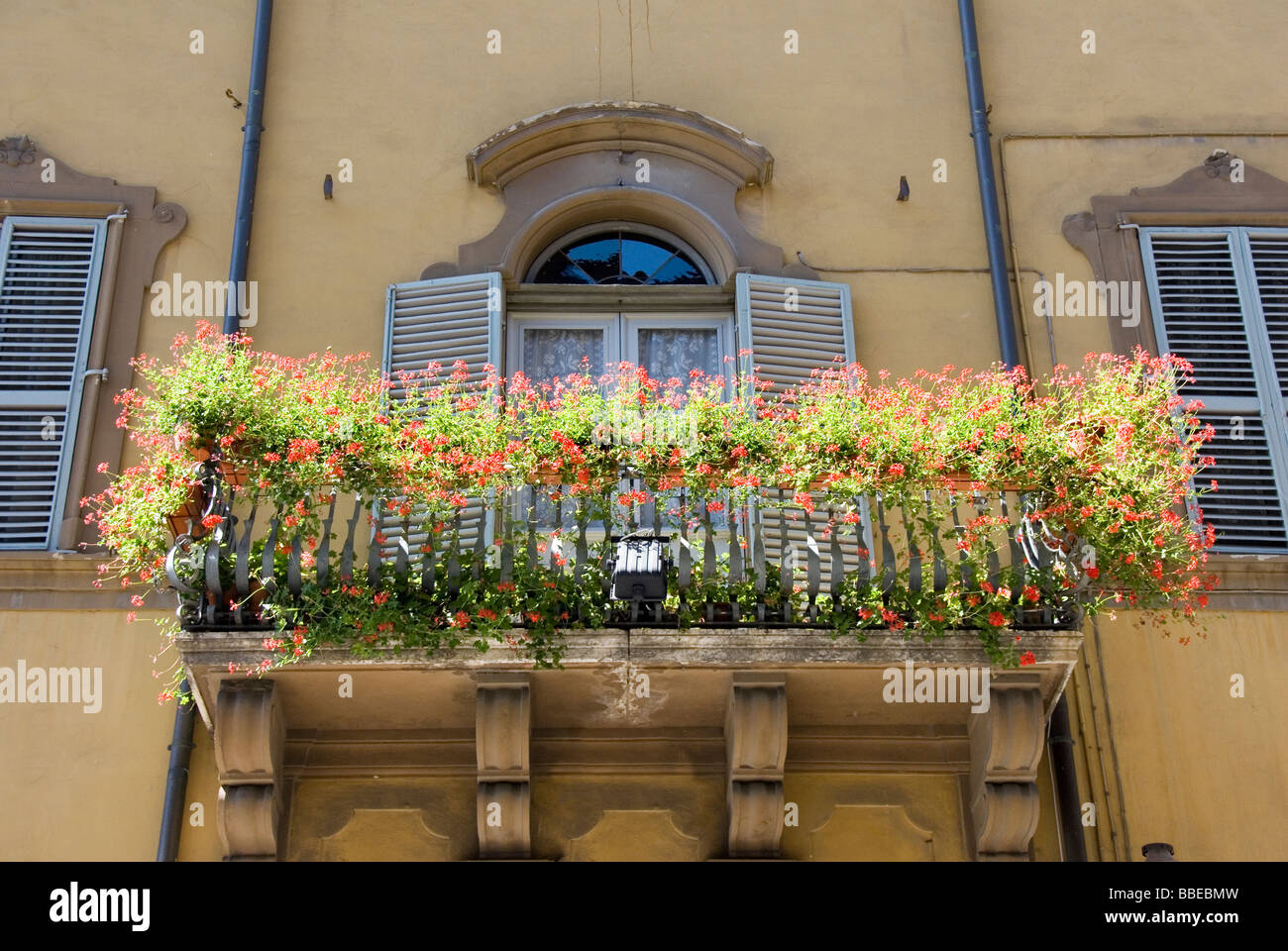 Un balcon avec des jardinières en terre cuite de géraniums rouge Banque D'Images