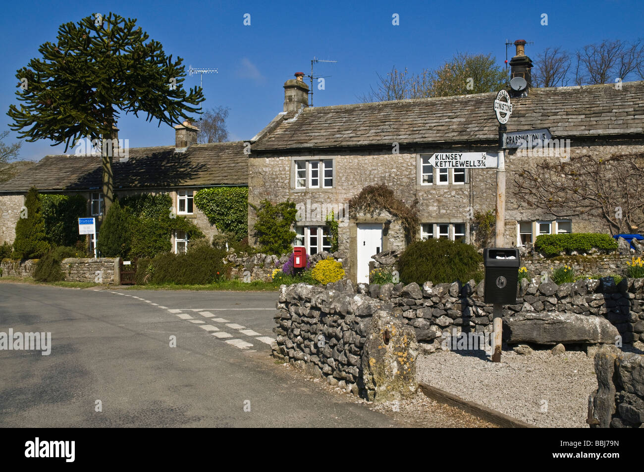 dh Yorkshire Dales National Park CONISTONE NORTH YORKSHIRE Village chalets et signpost Dales villages maison de campagne anglaise Banque D'Images