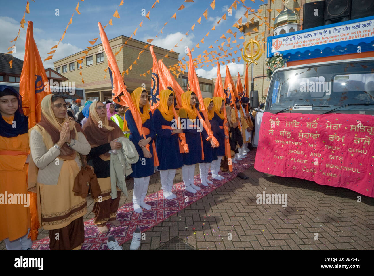 Les Sikhs à Hounslow prendre part à des célébrations du Vaisakhi et une procession. Les jeunes femmes Sikh Sikh avec drapeaux à l'avant du flotteur Banque D'Images