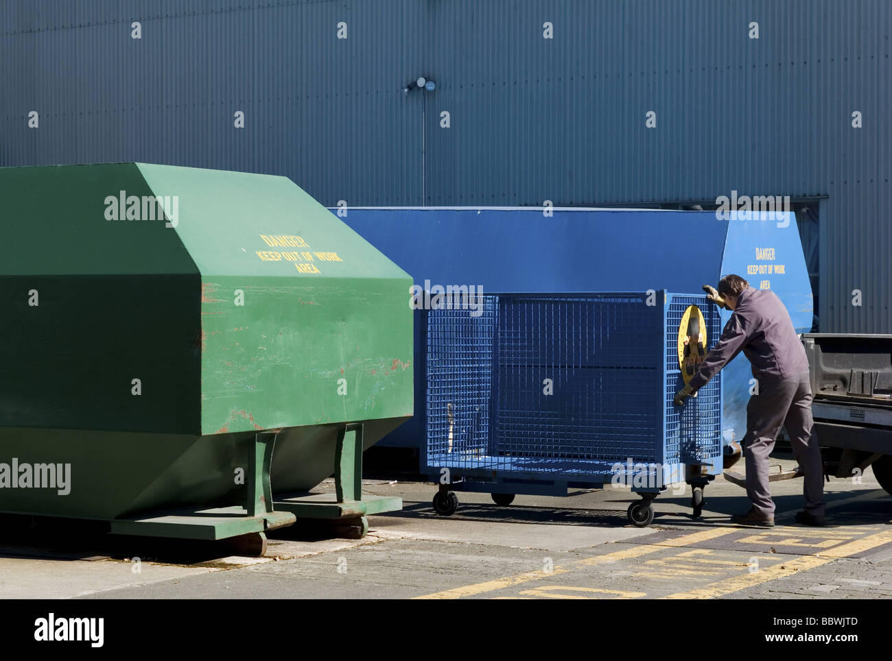 Homme poussant un bac bleu à Granville à Vancouver, Colombie-Britannique, Canada Banque D'Images