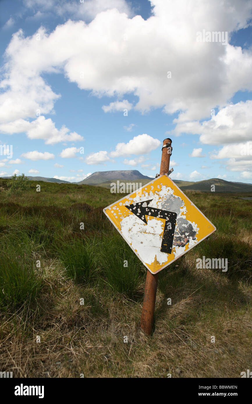 Un vieux panneau routier près de Parc national de Glenveagh, Co Donegal avec Muckish mountain en arrière-plan. Banque D'Images