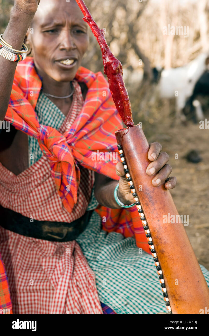 Masaï en remuant le sang de vache en calebasse - Maji Moto Village Maasai - près de Narok, Kenya Banque D'Images