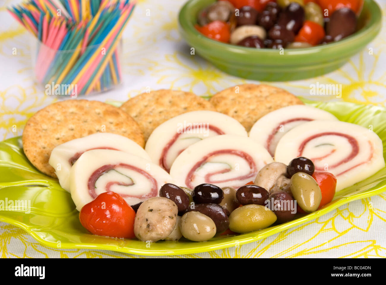 Une plaque snack délicieux de prosciutto au basilic jambon fromage rouleaux avec un assortiment d'olive et les craquelins Banque D'Images
