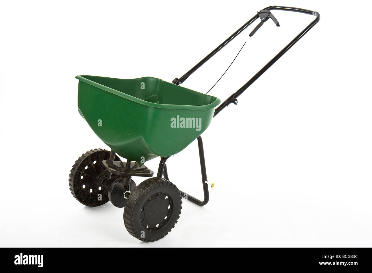 L'éparpilleur de semences vert sur fond blanc Banque D'Images