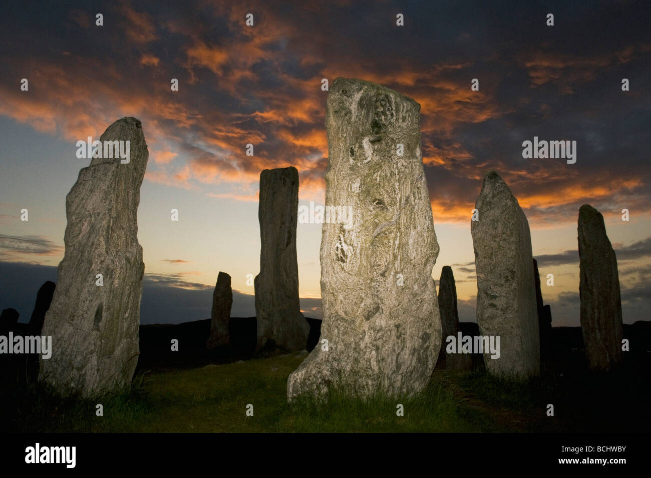 Le cercle de pierres néolithiques, Callanish Standing Stones, Coucher du soleil, le solstice d'été, à l'île de Lewis, Hébrides extérieures, en Écosse Banque D'Images