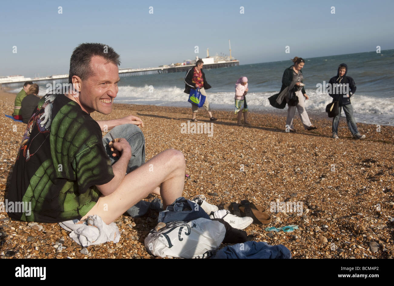 La nageuse froid remédie rapidement sur la plage en face de l'embarcadère après avoir pris un bain dans la mer à Brighton Banque D'Images