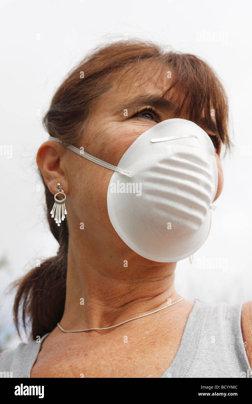 Femme d'âge moyen à l'extérieur le port de masque de filtre Banque D'Images