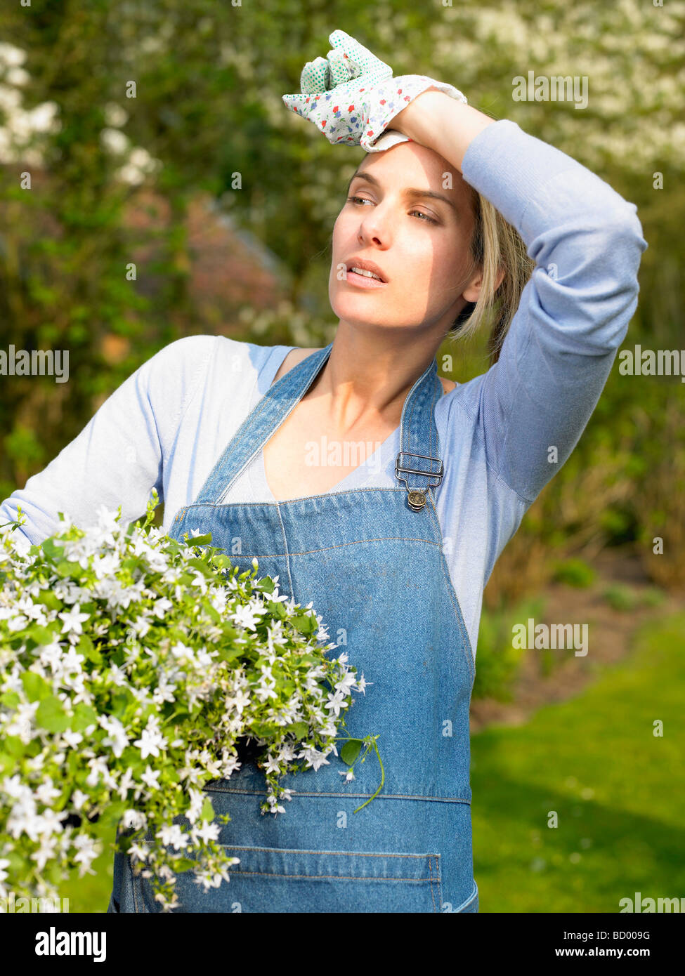 Femme tenant un pot de fleurs Banque D'Images
