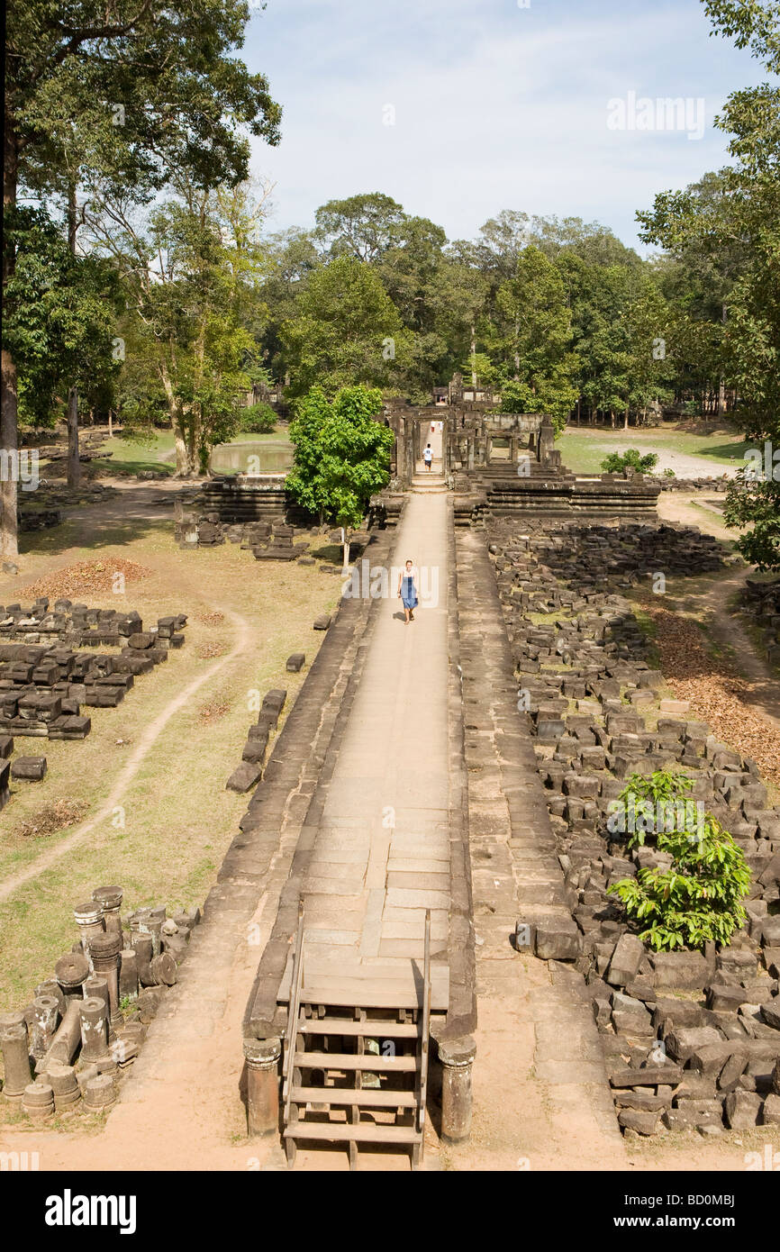 Woman walking along ruines du temple à Angkor, Cambodge Banque D'Images