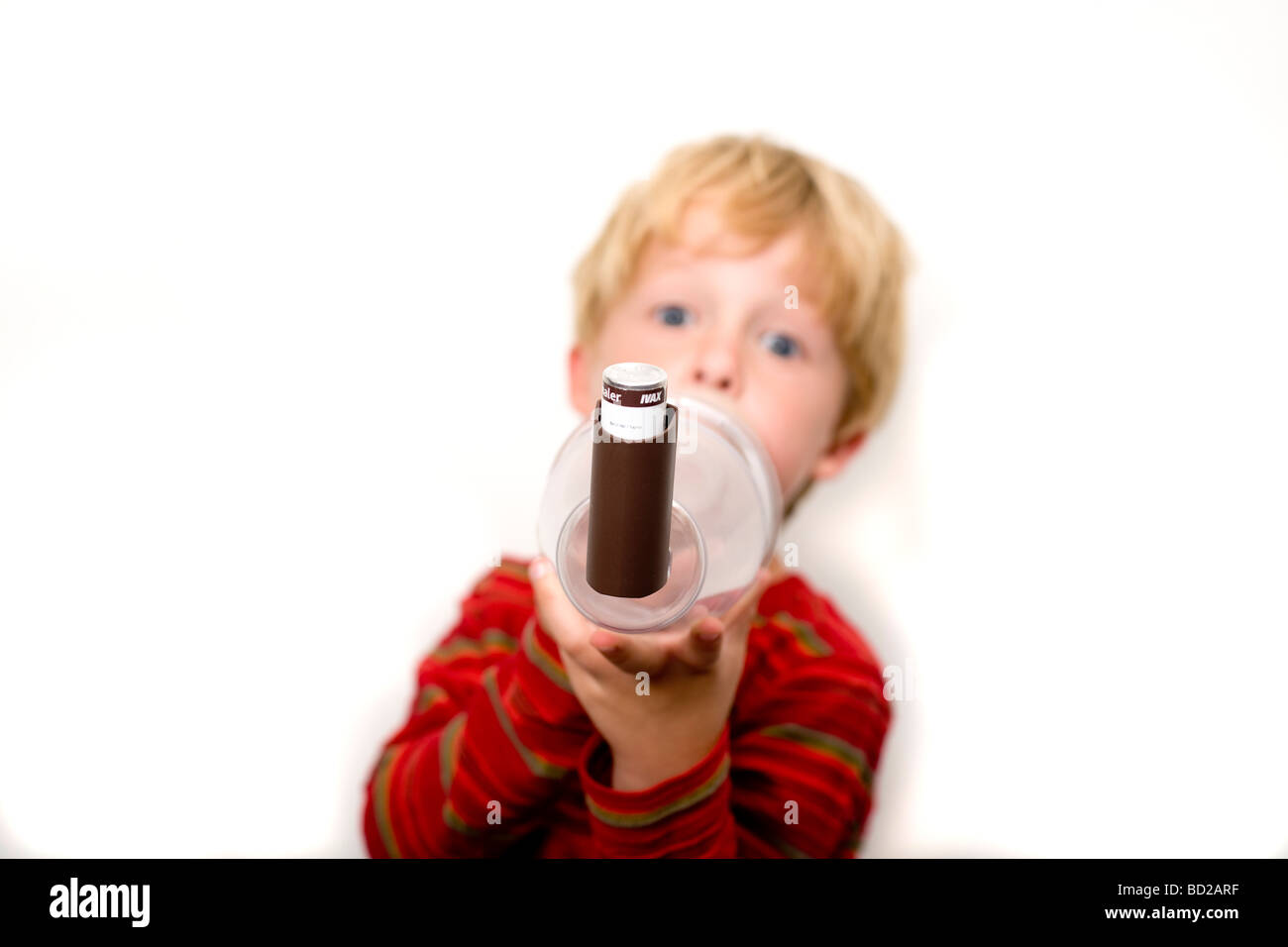 Garçon en utilisant l'asthme inhalateur avec spacer Banque D'Images