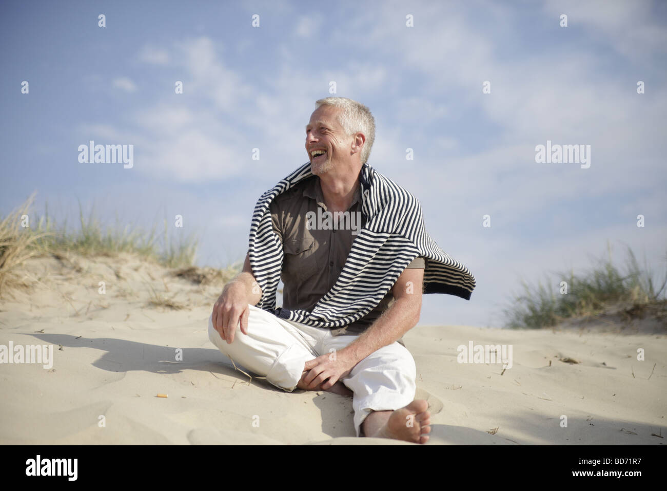 Best Ager hommes assis dans les dunes de la mer du Nord à De Haan, Belgique, Europe Banque D'Images