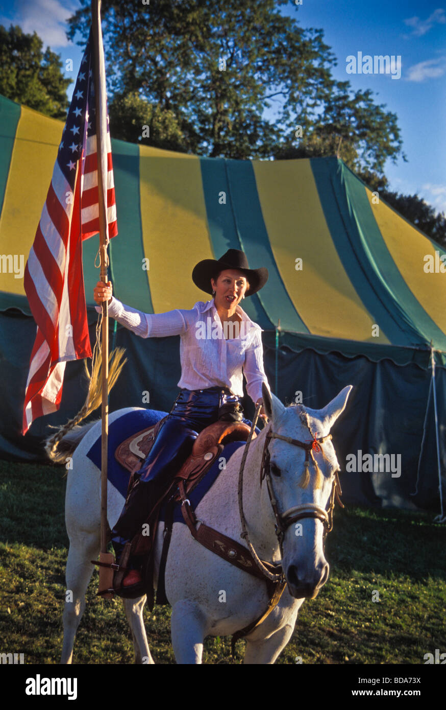 Jeune femme sur cheval blanc porte drapeau américain à la cérémonie  d'ouverture de county fair rodeo Photo Stock - Alamy