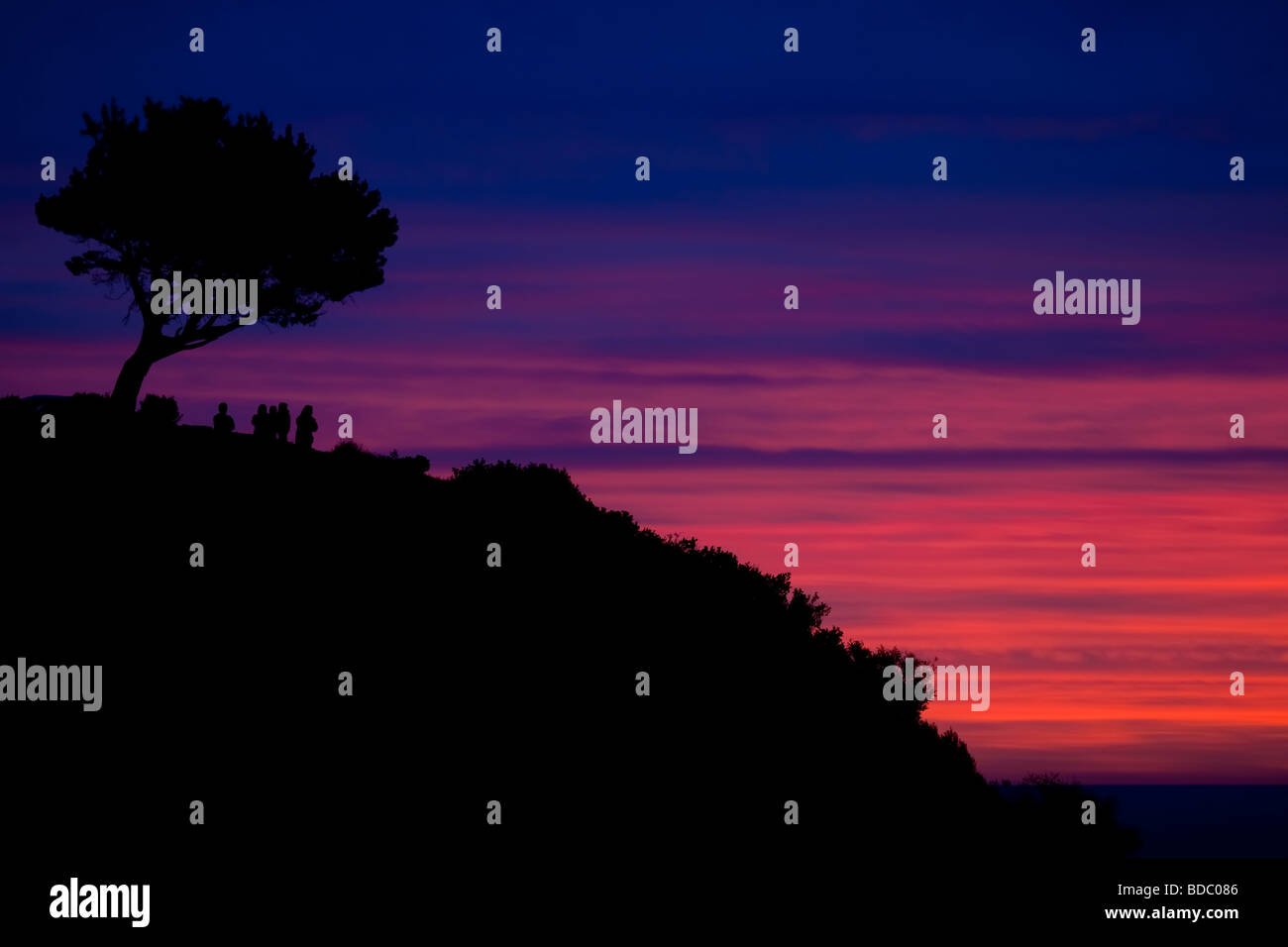 Groupe de personnes appréciant et incroyable coucher du soleil à Hout Bay Banque D'Images