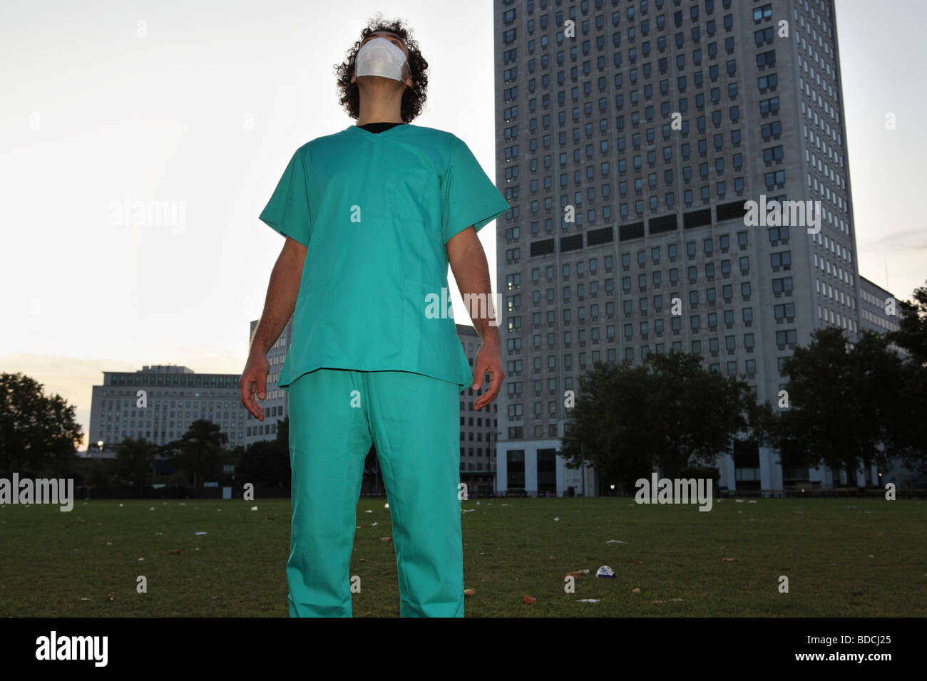 Un jeune homme avec un masque chirurgical et médical semble uniforme vers le ciel. Banque D'Images