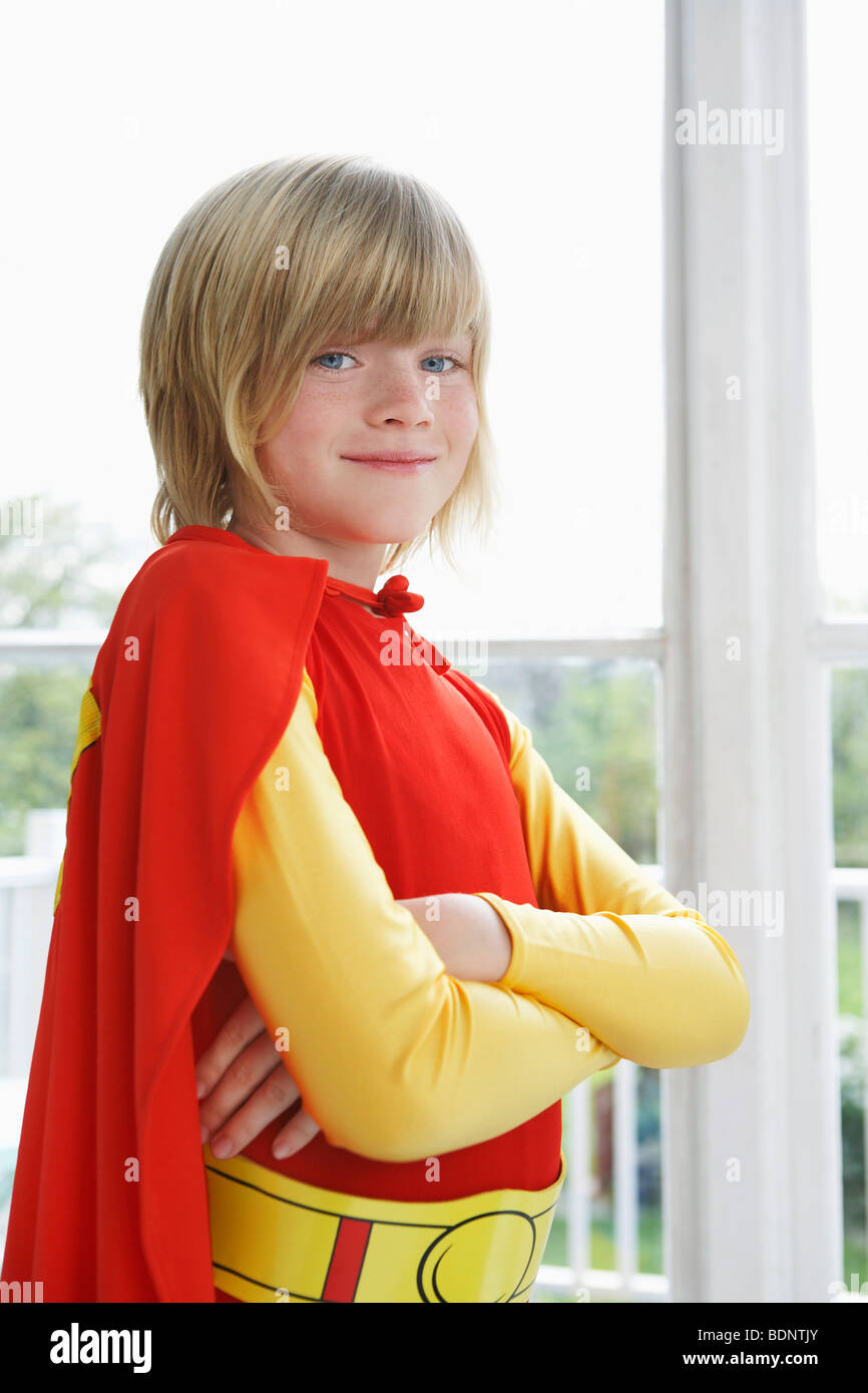 Portrait of Girl (7-9) with arms crossed wearing superhero costume, smiling Banque D'Images