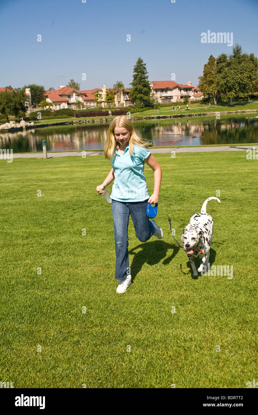 Caucasian junior high girl âge 11-13 ans ans enfant jouant jouer joue propriétaire de chien dalmatien Vue de face à l'appareil photo MR © Myrleen Pearson Banque D'Images