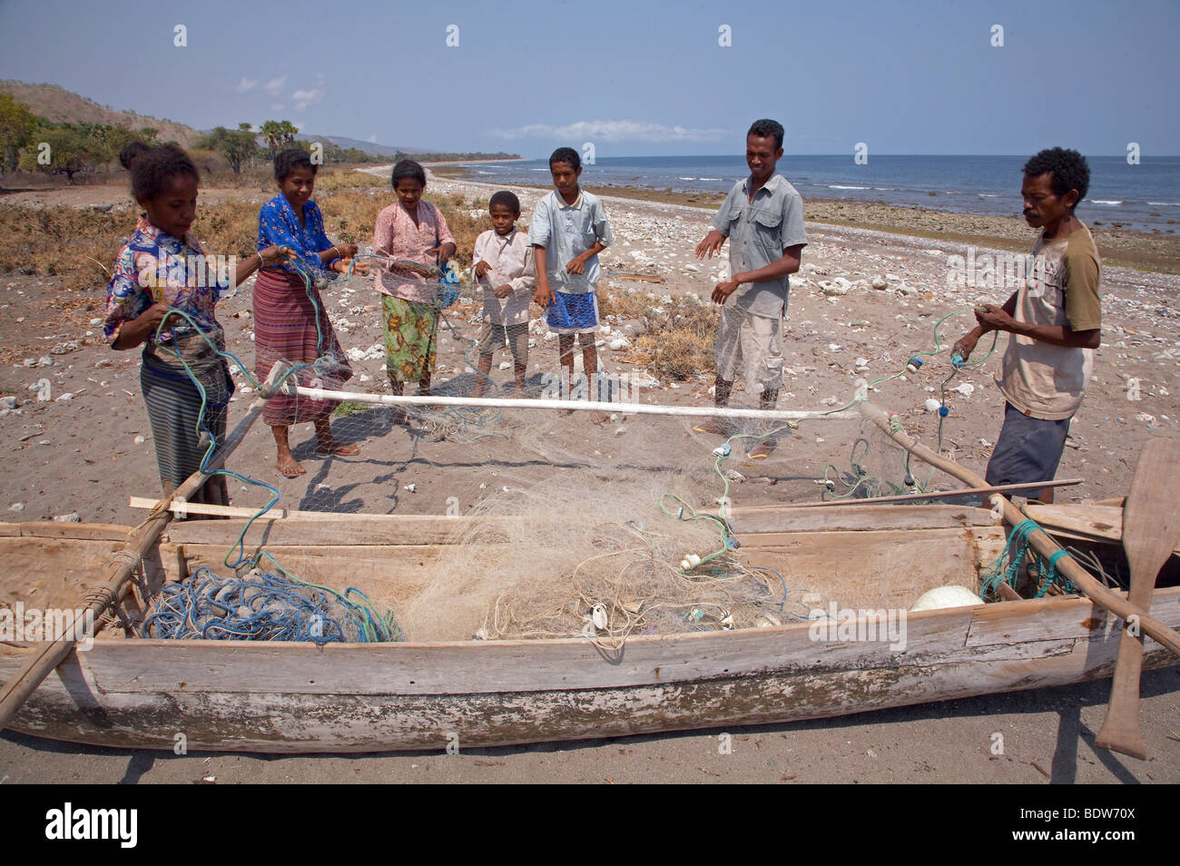 TIMOR LESTE Sebastian Anin (droite), pêcheur, et de la famille de la préparation des filets, Aosera Oecussi-Ambeno, village Banque D'Images