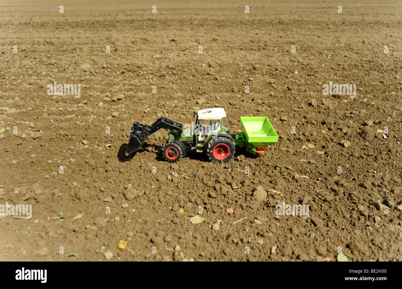 Tracteur jouet en plastique sur terrain Banque D'Images