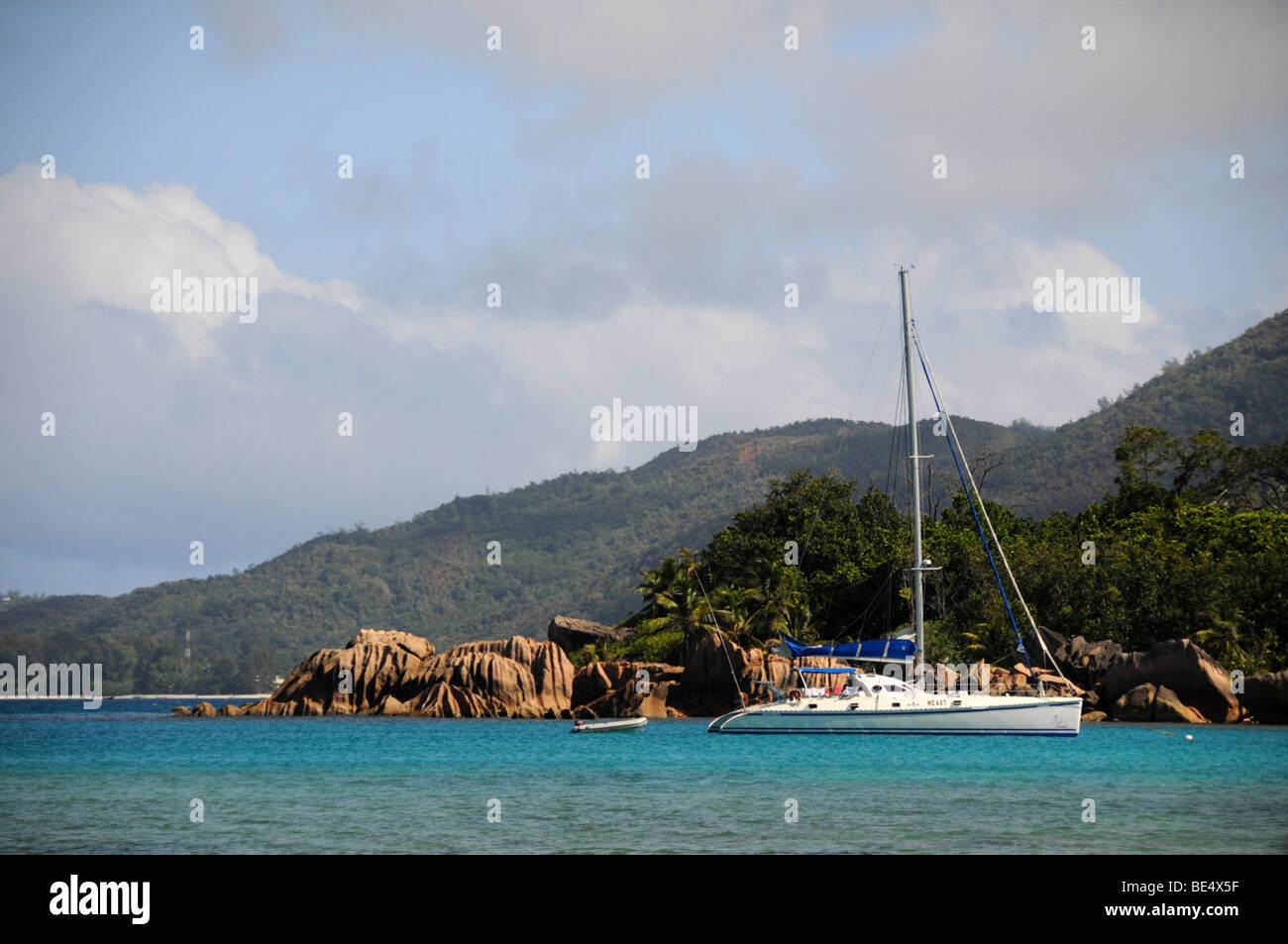 Catamaran en face de rochers de granit, l'île Curieuse, Seychelles, Afrique, Océan Indien Banque D'Images