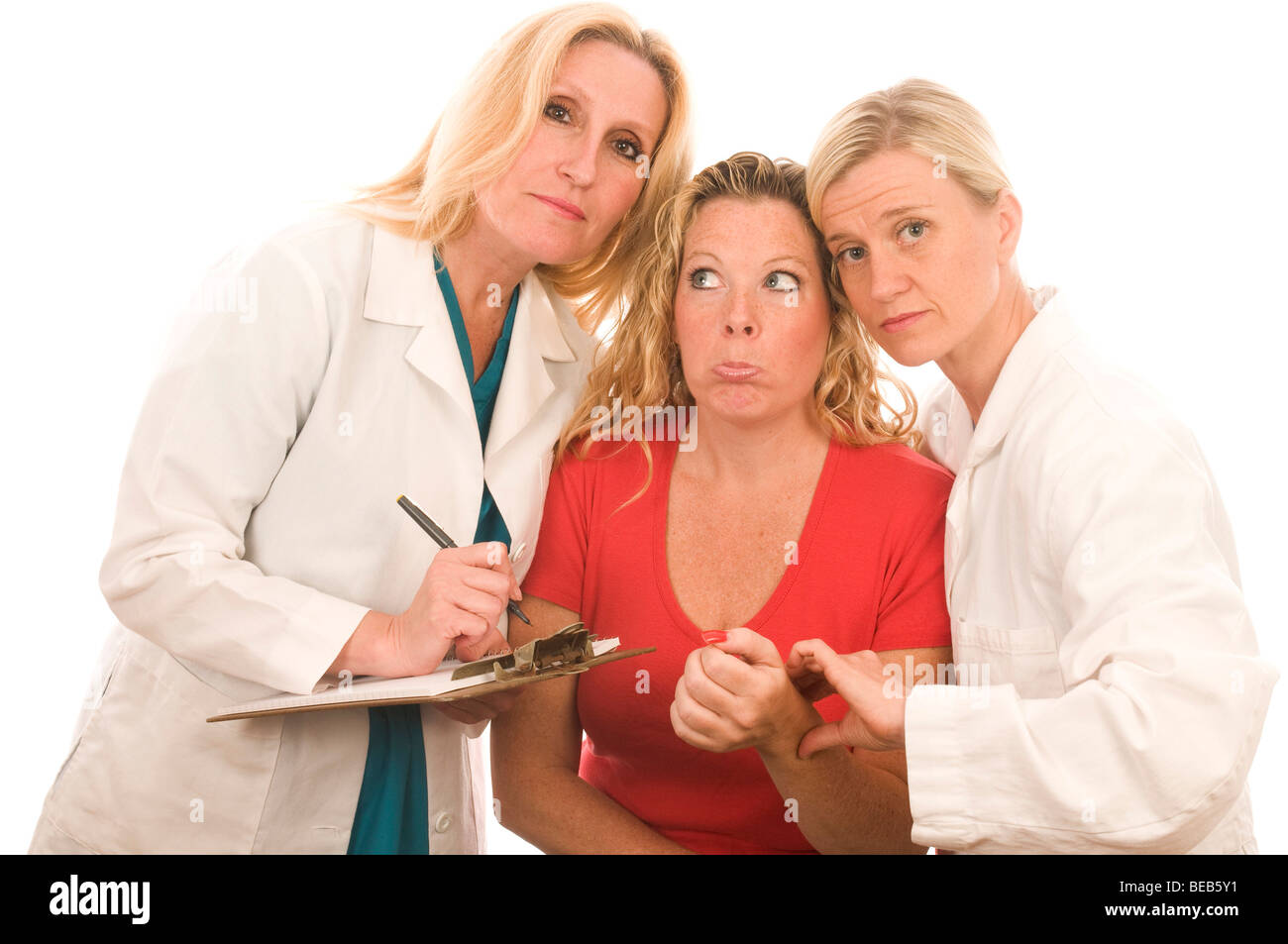 Trois infirmières infirmière de l'équipe dame Dames Femmes Groupe d'équipe assez patient test de pression du sang bureau hôpital lire l'aide de lecture Banque D'Images