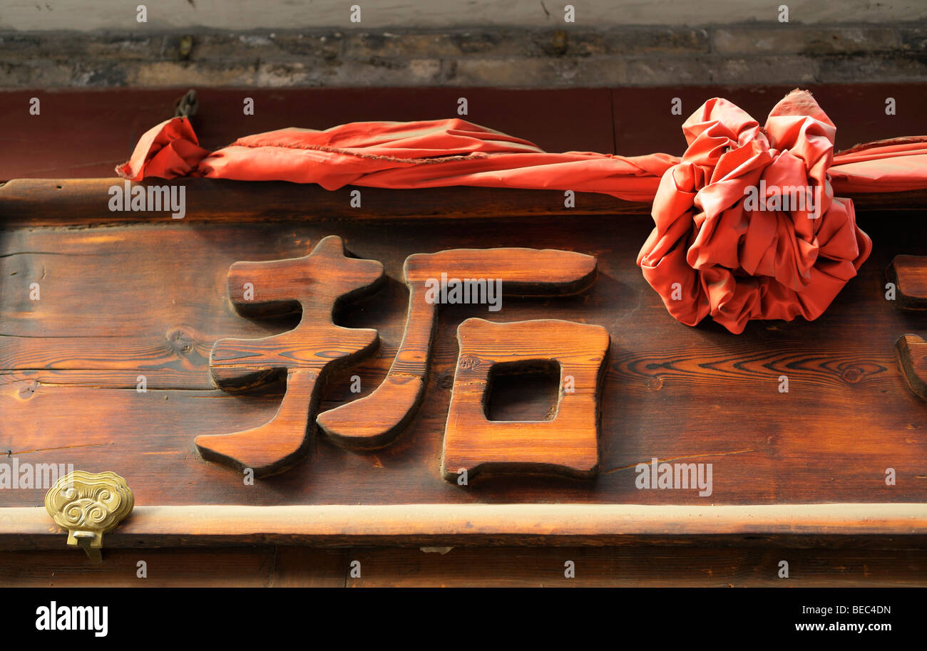 Kanji chinois sculpté dans une plaque de bois, Beijing CN Banque D'Images