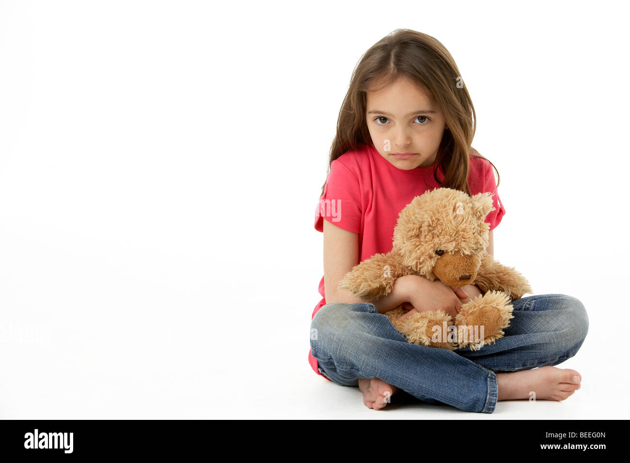 Studio Portrait Of Smiling Girl with Teddy Bear Banque D'Images