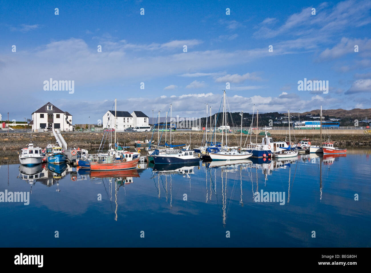Les navires amarrés dans Kylakin Harbour sur l'île de Skye en Ecosse sur une journée ensoleillée d'automne avec Kyle of Lochalsh sur le Loch Alsh Banque D'Images