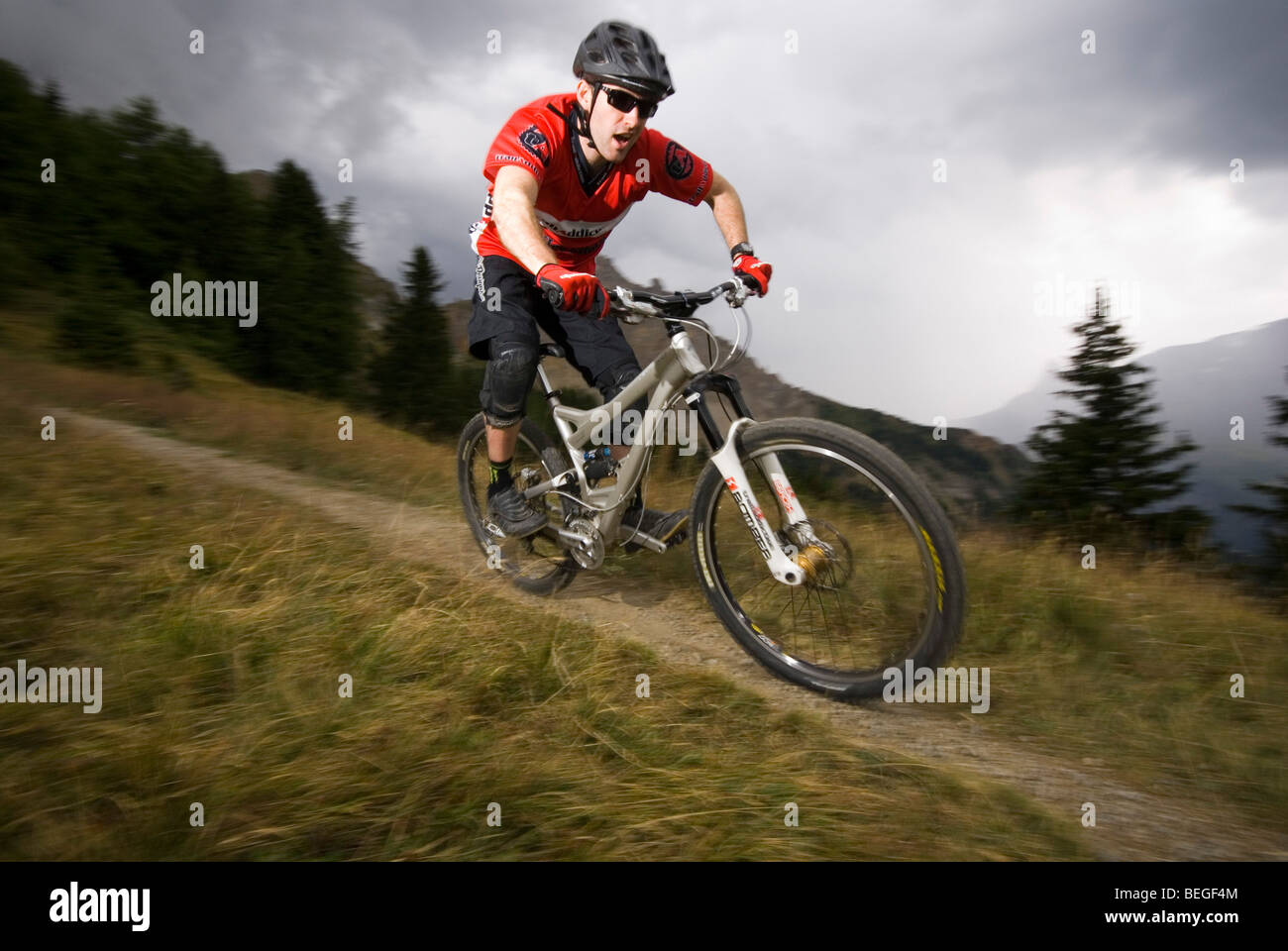 Un vélo de montagne monte un sentier singletrack dans Les Arcs dans les Alpes françaises. Banque D'Images
