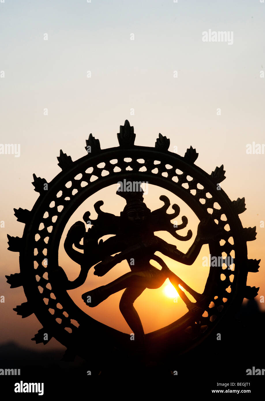 Seigneur dansant Shiva Nataraja, statue, silhouette contre un indien le lever du soleil. Puttaparthi, Andhra Pradesh, Inde Banque D'Images