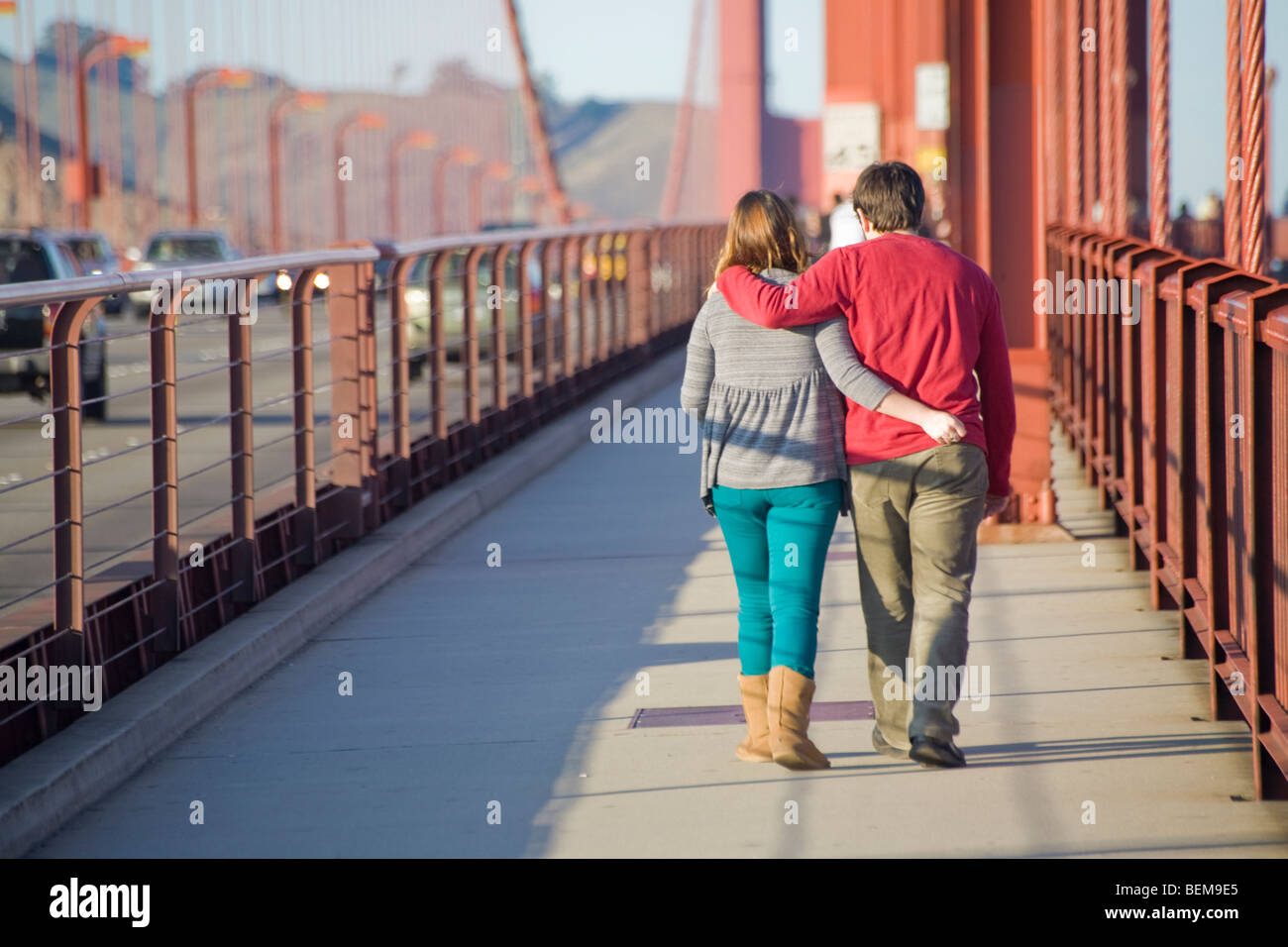 Une vue arrière d'un couple en train de marcher sur le Golden Gate Bridge. San Francisco, California, USA Banque D'Images