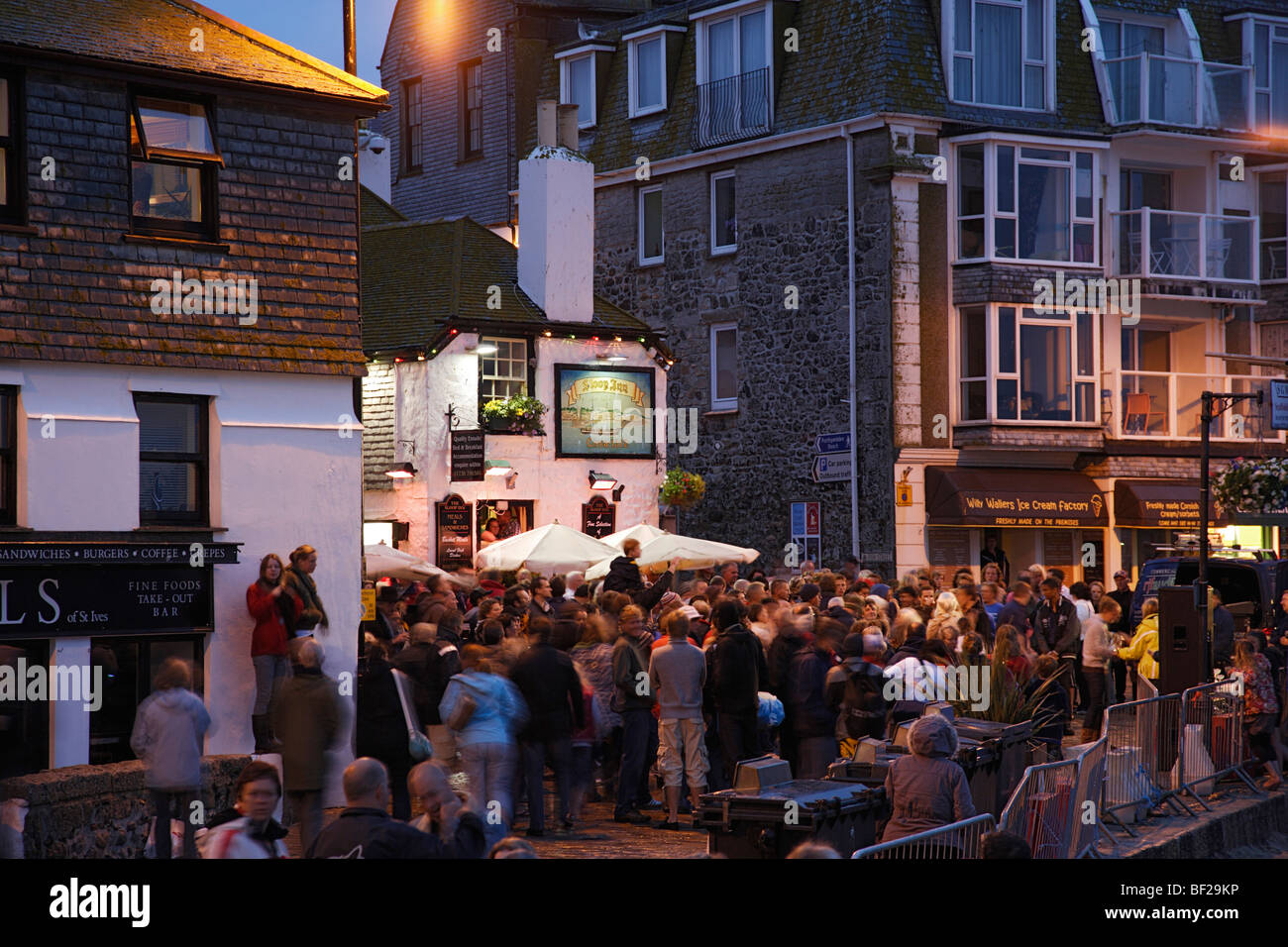 Foule sur un carré dans la soirée, St Ives, Cornwall, Angleterre, Royaume-Uni Banque D'Images