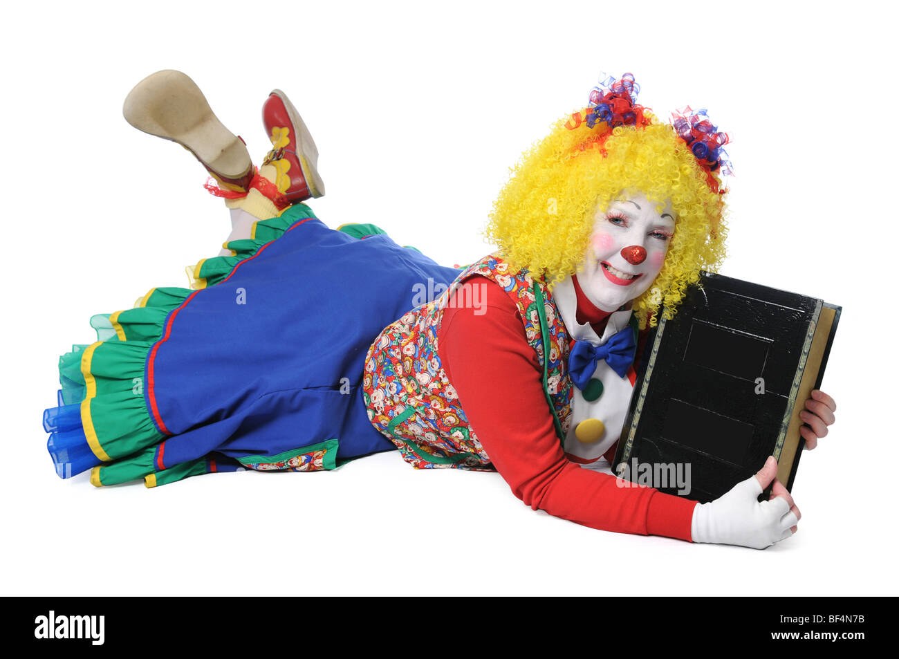 Clown fixant les grandes holding book Banque D'Images