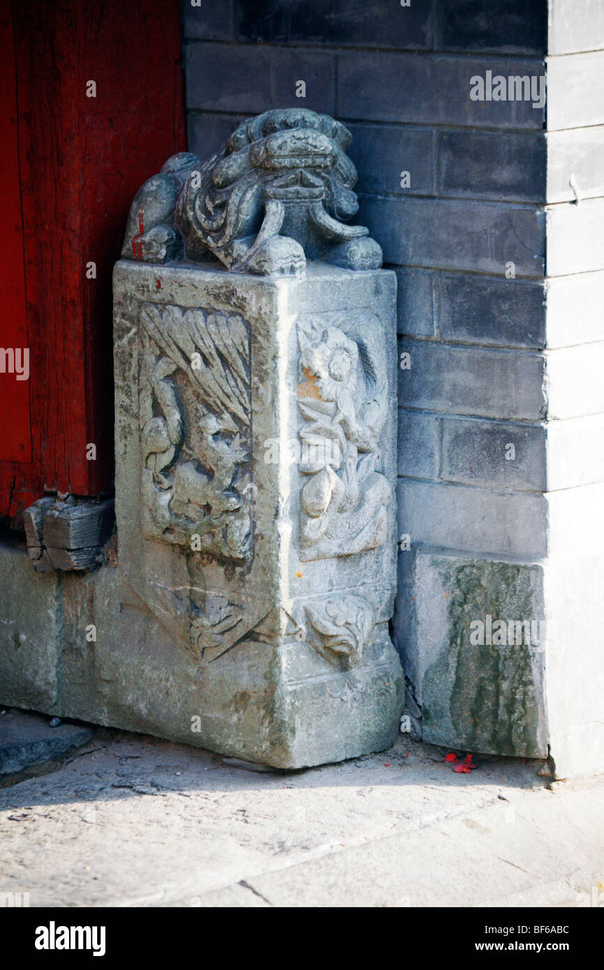 Mendun avec lion sculpté motif à fleurs et gardant la porte d'un Hutong courtyard House, Beijing, Chine Banque D'Images