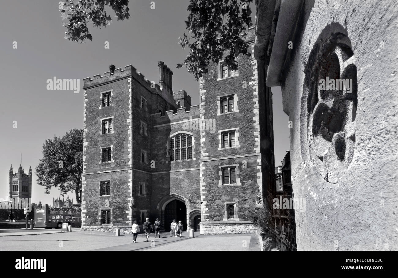 Façade Tudor et châtelet d'entrée à Lambeth Palace avec les Chambres du Parlement et le bus touristique derrière Lambeth London UK B +W Banque D'Images