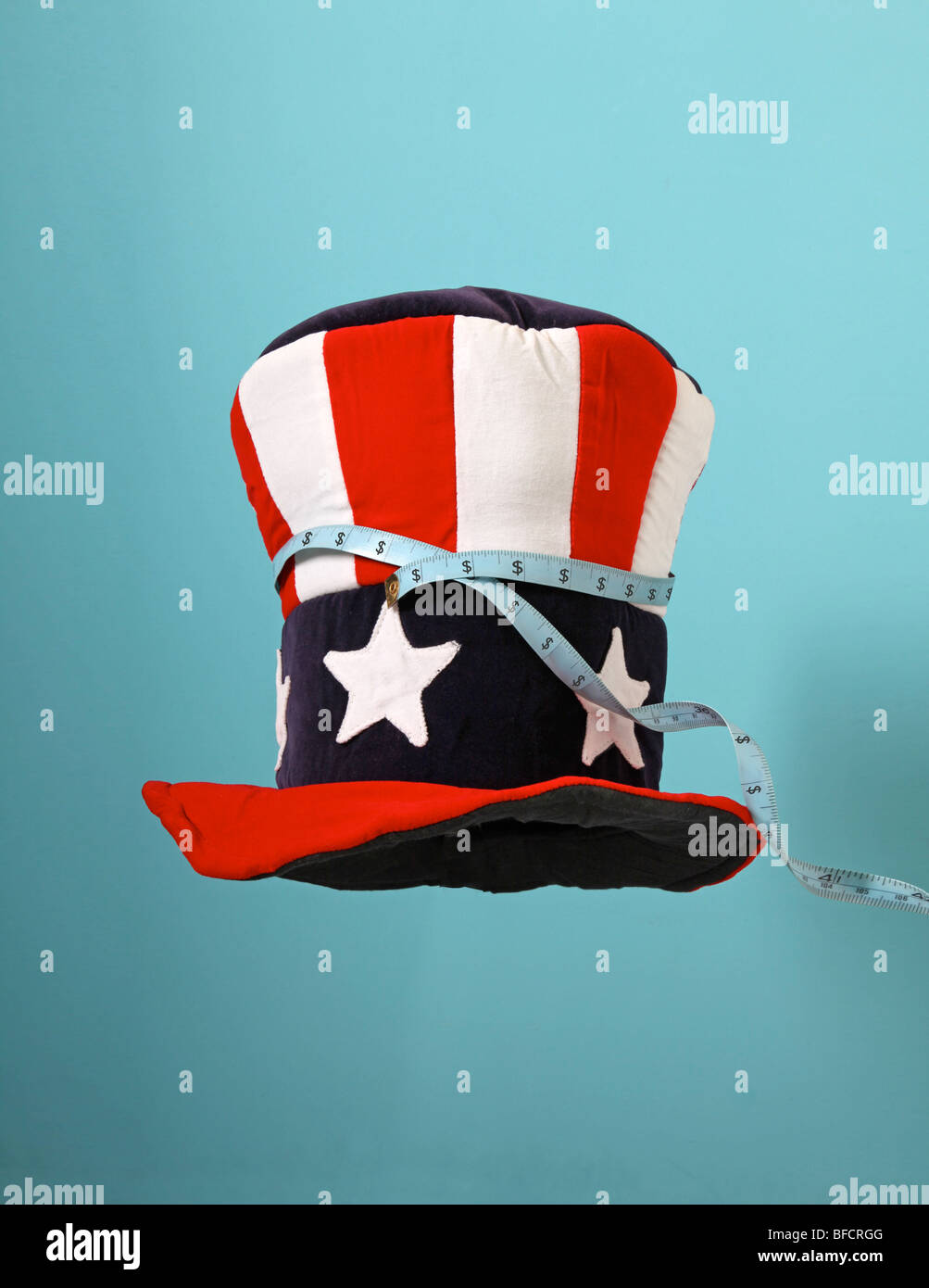 L'Oncle Sam américain chapeau avec un ruban à mesurer montrant des signes dollar. Banque D'Images